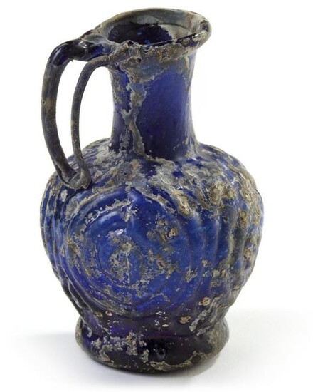 A SMALL BLUE MOULDED GLASS EWER, SYRIA, 10TH CENTURY