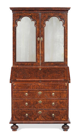 A William III or Queen Anne figured walnut and featherbanded bureau cabinet