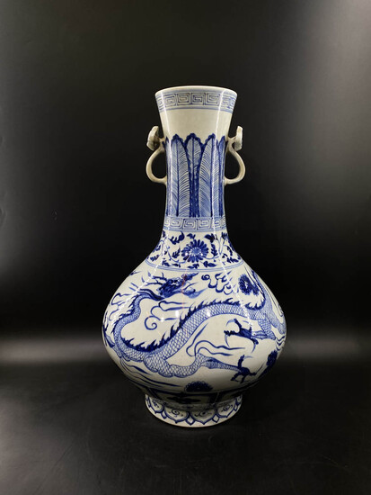 A blue and white hand-painted dragon porcelain vase with...