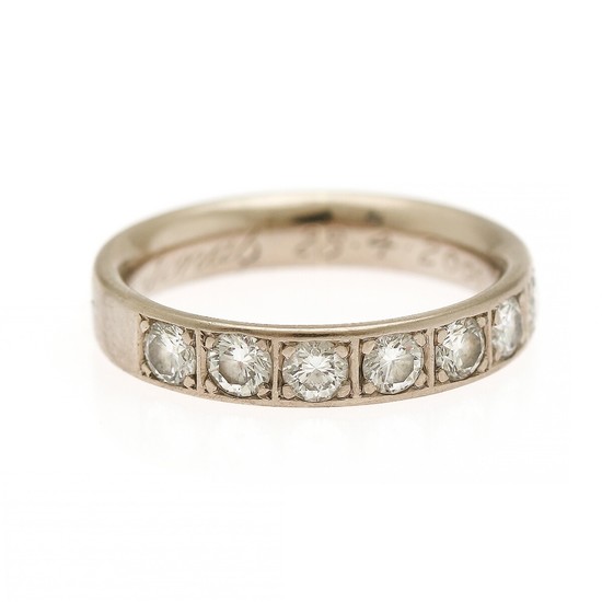 A diamond eternity ring set with seven brilliant-cut diamonds, mounted in 14k white gold. Size 50.