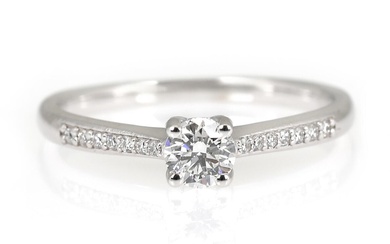 A diamond ring set with a diamond weighing app. 0.30 ct. flanked...