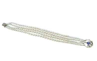 A four row pearl bracelet with a sapphire and diamond clasp
