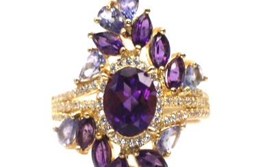 A gold on 925 silver ring set with amethysts and tanzanites, L. 3cm, ring size O.