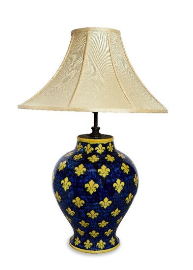 A large modern Italian glazed pottery table lamp, of baluster form decorated with fleur-de-lys, 41cm high excluding fitment Provenance: The Geoffrey and Fay Elliot collection. It is the buyer's responsibility to ensure that electrical items are...