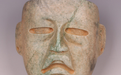 A large pre-Columbian Olmec style finely carved green hardstone mask, probably 900-450 BC, with pier