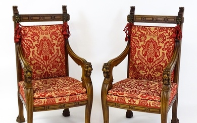 A pair of 19thC continental mahogany armchairs surmounted by...