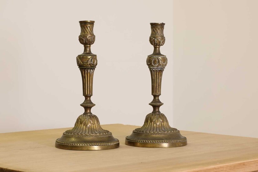A pair of French bronze candlesticks