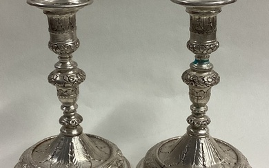 A pair of early Queen Anne cast silver candlesticks. Circa 1...