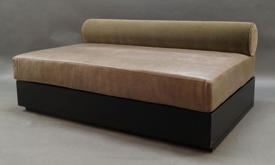 A pair of contemporary sofa/daybeds, of recent manufacture, with velvet upholstered bolster shaped backrest over rectangular brown leather seat on ebonised plinth base and castors, 67cm high, 155cm wide, 100cm deep (2)