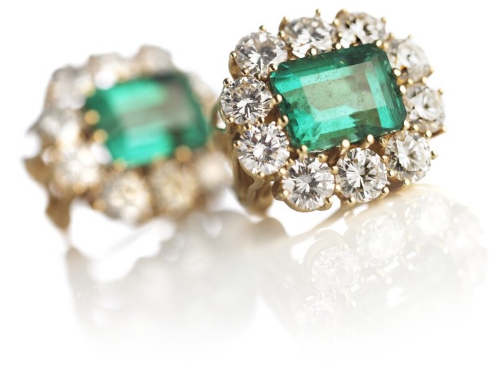 A pair of emerald and diamond ear pendants each set with an emerald-cut emerald encircled by numerous brilliant-cut diamonds, mounted in 18k gold. G-H/VS. (2)