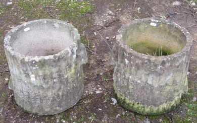 A pair of weathered cast composition stone garden planters i...
