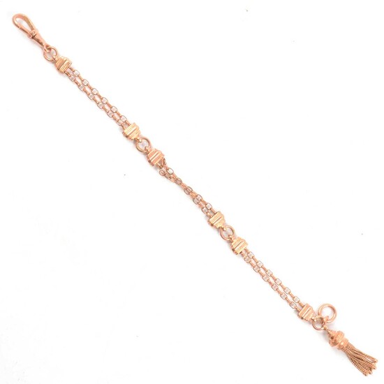 A rose metal albertine bracelet with tassel.