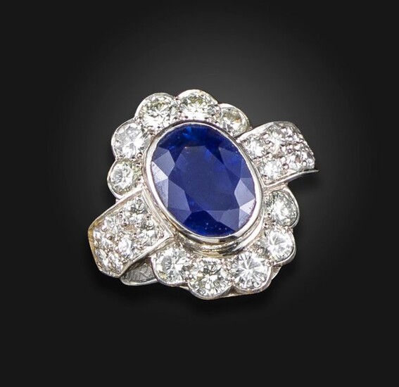 A sapphire and diamond cluster ring by Geoffrey Rowlandson, centred...
