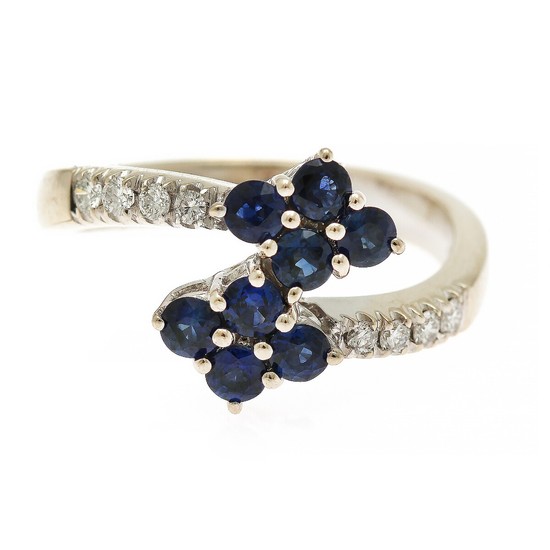 A sapphire and diamond ring set with eight sapphires and ten brilliant-cut diamonds, mounted in 18k white gold. Size 56.