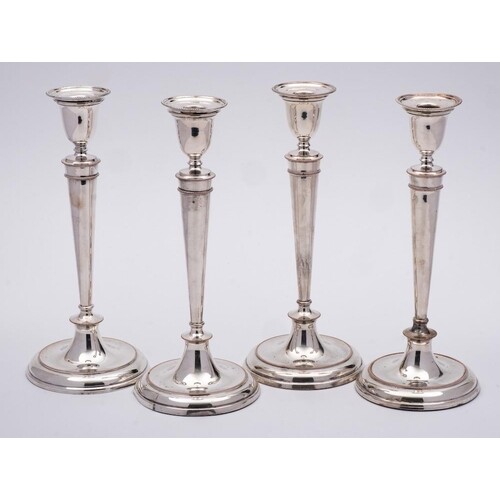A set of four 19th Century silver plated candlesticks: with ...
