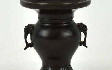 A small 19th century Chinese bronze vase with calligraphy mark...