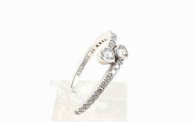 A sterling silver crossover ring set with heart and round cut colourless cubic zirconia