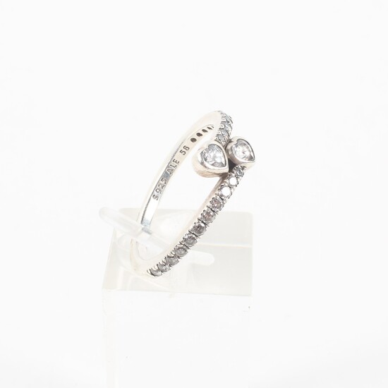 A sterling silver crossover ring set with heart and round cut colourless cubic zirconia