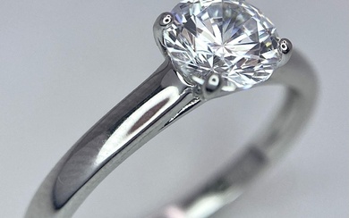 A sterling silver solitaire ring with a round cut...