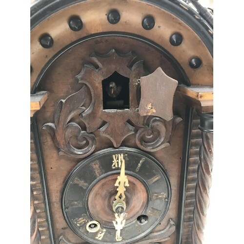 A walnut case cuckoo clock