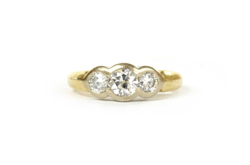 An 18ct gold three stone diamond ring