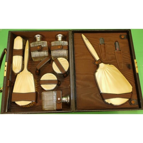 An 8 Piece London Silver Dressing Table Set, fitted brown le...