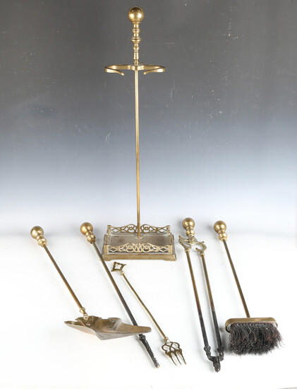 An Art Nouveau brass fireside companion, comprising shovel, length 69cm, poker, tongs, brush and an