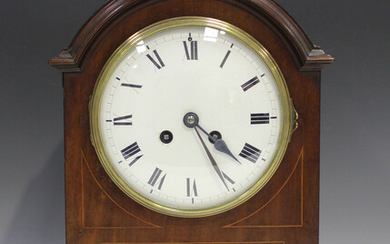 An Edwardian mahogany mantel clock with eight day movement striking on a gong, the white enamel circ