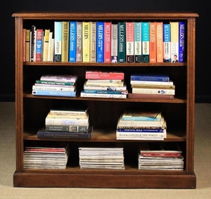 An Oak Bookcase of Reference Books pertaining to antiques. The moulded top above reeded sides flanking four open-fronted shelves above a plinth base 48 in (122 cm) high, 48 in (122 cm) wide, 12 in (31 cm) deep. The books including a quantity of