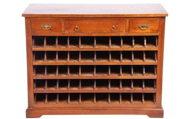 An early 20th-century French cherry wood Sommelier's wine rack, cupboard, fitted with three frieze