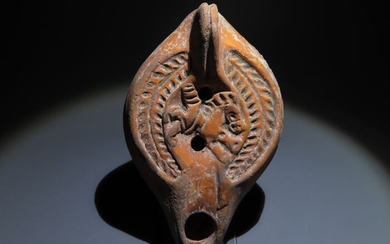 Ancient Roman Terracotta Oil lamp with a horse relief. c. 1st - 3rd Century AD. 13 cm L. Nice decoration.