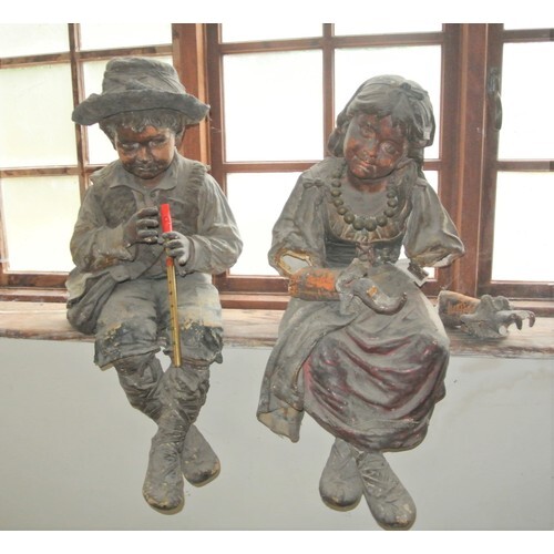 Pair of Dutch style plaster figures of seated children (f)