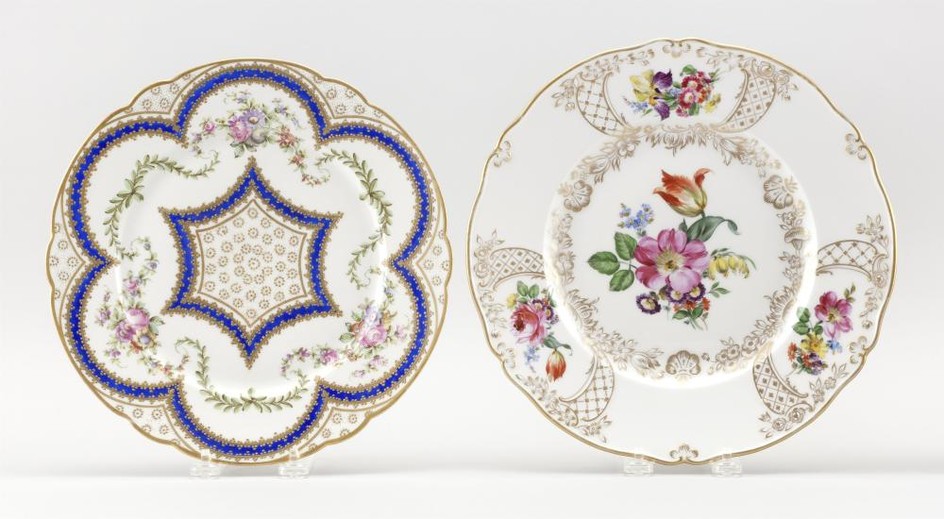 TWO PORCELAIN SERVICE PLATES 1) Meissen, with hand-painted flower sprays and raised gilt details. Second-quality crossed swords mark...