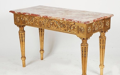 Table console en bois doré reposant sur quatre pieds fuselés à cannelures rudentées. Ceinture ornée...