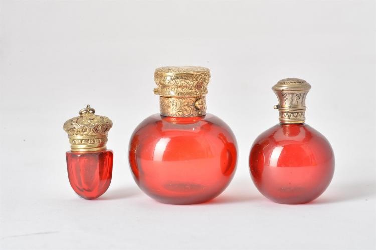 Two 19th century ruby glass spherical scent bottles and a ruby glass vinaigrette