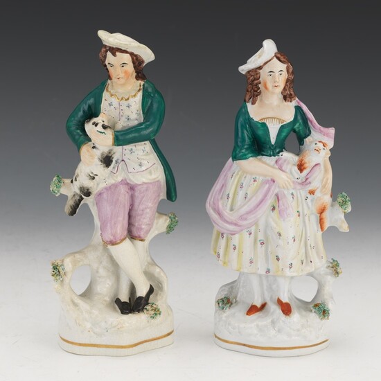 Two Staffordshire Figures of Man and Woman with Dogs