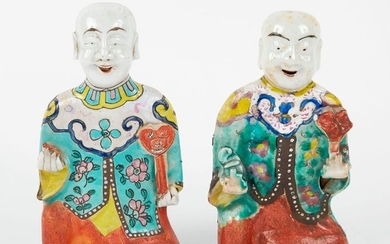 Two polychrome enamelled porcelain figures kneeling holding a...