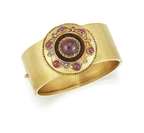 A 19TH CENTURY GARNET BANGLE, the 25mm wide hinged