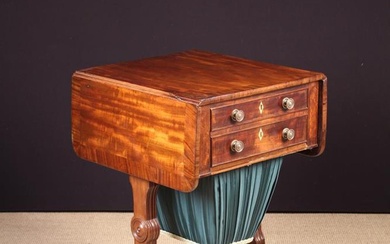 A 19th Century Fitted Mahogany Work Table. The cross-banded top having two drop leaves with rounded