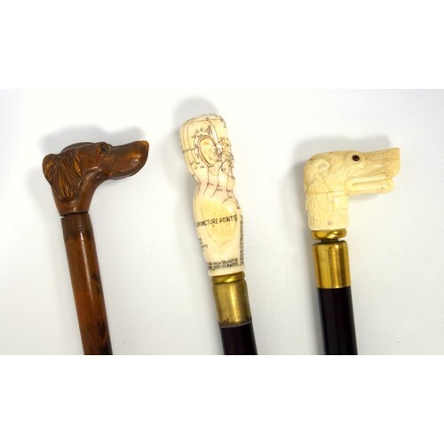 A 19th century ivory mounted walking cane, the pommel carved...