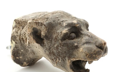 A 20th century patinated plaster fragment in the shape of a lion...