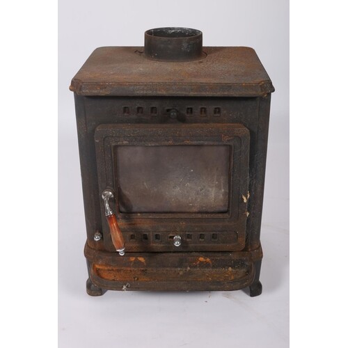 A CAST IRON FREE STANDING SOLID FUEL STOVE on moulded legs 6...