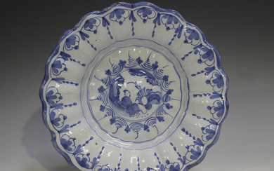 A Delft moulded dish, 18th century, painted in blue with a chinoiserie style figure within a landsca