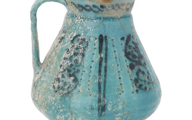A Kashan turquoise glazed footed pottery jug, Kashan, central Persia, 12th century,...