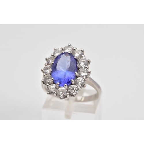 A MODERN LARGE TANZANITE AND DIAMOND OVAL CLUSTER RING, an o...