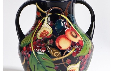 A Moorcroft twin handled pottery vase decorated in the Queen...