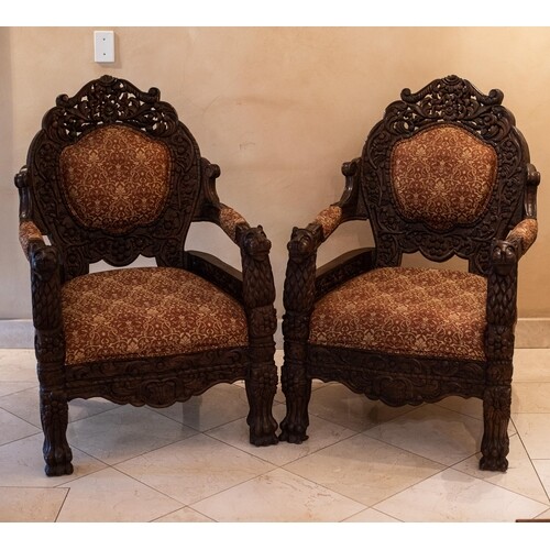 A PAIR OF INDIAN ARMCHAIRS Each carved and pierced padded ba...