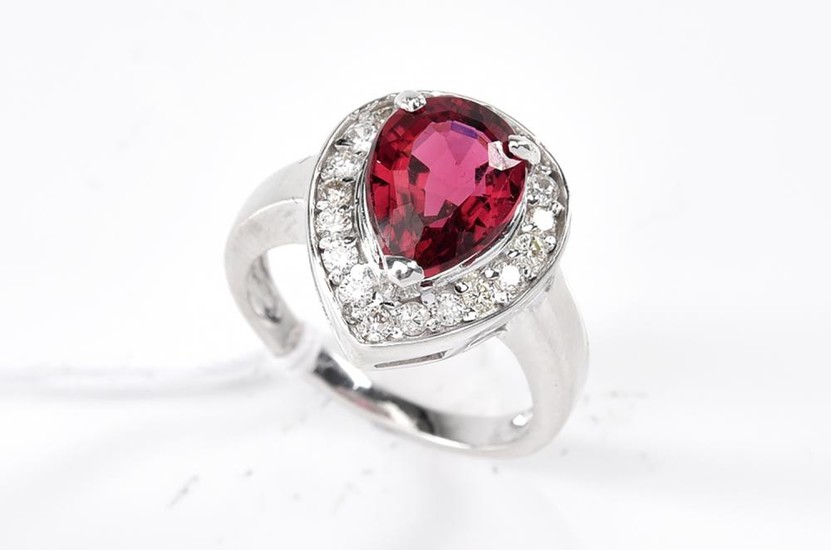 A TOURMALINE AND DIAMOND RING-The pear cut pink tourmaline weighing 2.88cts, surrounded by round brilliant cut diamonds totalling 0....