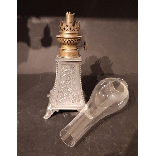 A VICTORIAN PEWTER BASE OIL LAMP, on shaped base with floral...