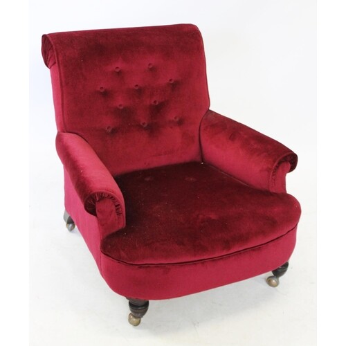 A Victorian claret upholstered arm chair, the deep set butto...